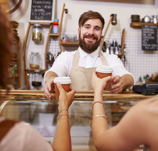 Man serving coffee cups to customers